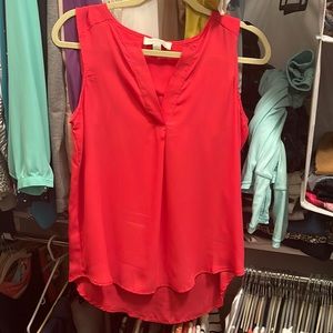 Reddish pink sleeveless blouse
